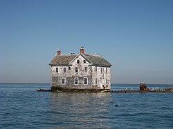 The last remaining house on Holland Island that collapsed and was torn down in the 2010s as erosion and tides reached the foundation.