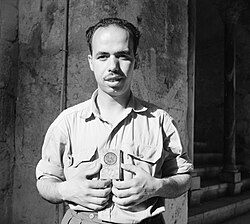 A Syrian holds a Muslim Brotherhood symbol, Aleppo, 1950.