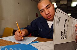 A U.S. Navy sailor taking the SAT aboard the U.S.S Kitty Hawk (CV-63) in 2004