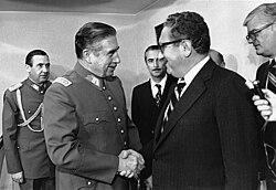 Chilean dictator Augusto Pinochet shaking hands with Henry Kissinger in 1976