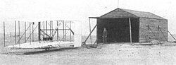 The Wright Flyer outside the aircraft's makeshift hangar