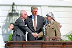 Yitzhak Rabin and Yasser Arafat at the signing ceremony of the Oslo Accords peace agreements, with then US President Bill Clinton (center)