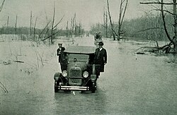 A car in the middle of the Great Mississippi Flood 1927.