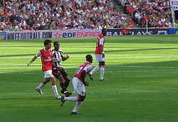 Fàbregas (left) in a game against Sheffield United in September 2006