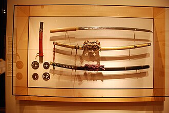 Japanese swords: tachi (right), wakizashi (top left), and tsuba guards (bottom left)