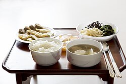 Simple Korean table (chopsticks and a spoon placed palewise, on the right side of rice and soup)