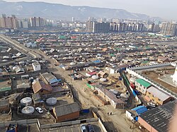 Ger districts against a backdrop of new high-rise buildings in Ulaanbaatar