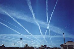 Water vapor contrails left by high-altitude jet airliners. These may contribute to cirrus cloud formation.