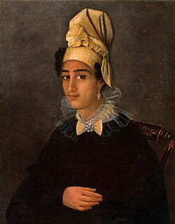 A young Creole woman wearing a tignon of her own creation.