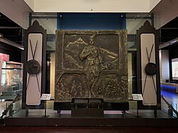 The bronze mural of the legendary Malay warrior, Hang Tuah with his renowned quote Ta' Melayu Hilang Di-Dunia (Malay for "Never shall the Malays vanish from the face of the earth") written on the top. The quote is a famous rallying cry for Malay nationalism.[107][108]