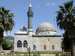 The Green Mosque in İznik (1378–1391) is an early example of the single-domed mosque type. The prayer hall is covered by a large dome (right), while its entrance is preceded by a portico covered by smaller domes (left).
