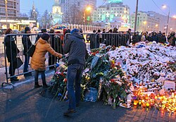 People lay flowers outside the French embassy in Moscow in memory of the victims of the November 2015 Paris attacks.