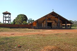 A wooden bell-tower and a church in frontal view (2009)