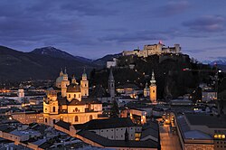 View from Mönchsberg (left to right), Kollegienkirche (right behind Salzburger Dom), Franziskanerkirche, St Peter's Abbey, Salzburg and, in the background, Hohensalzburg Fortress