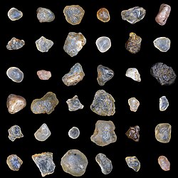 Sand grains of yellow building sand. Microscope Lumam P-8. EPI lighting. The photo of each grain of sand is the result of multifocal stacking.