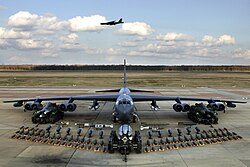 Boeing B-52H static display with weapons, Barksdale Air Force Base 2006. A second B-52H can be seen in flight in the background.