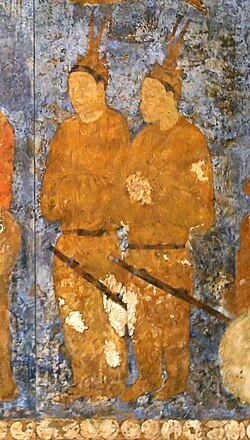 Korean (Goguryeo) ambassadors during an audience with King Varkhuman of Samarkand. They are identified by the two feathers on top of their head.[69] 648–651 AD, Afrasiab murals, Samarkand.[70][71]