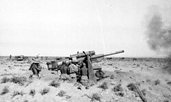 Near Bir Hacheim: 8.8cm Flak guns firing; Rommel's vehicle in the background