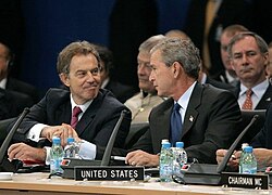 Shaking hands with US president George W. Bush at a NATO summit in Turkey, June 2004