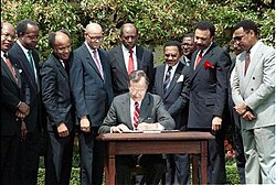 President George H. W. Bush signs a new Executive Order on historically Black colleges and universities in the White House Rose Garden, April 1989.
