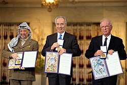 Yasser Arafat, Shimon Peres and Yitzhak Rabin displaying their 1994 Nobel Peace Prize