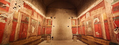 A room with frescos along the walls