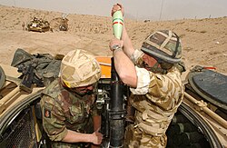 British soldiers from the 1st Armoured Division engage Iraqi Army positions with their 81mm mortar in Iraq, 26 March 2003.