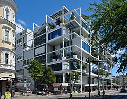An inner-city IKEA store in Vienna, Austria, featuring a shelf-like grid facade integrated with live trees and greenery