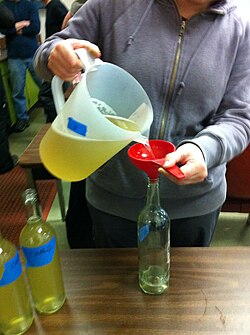 Winemaker conducting fining bench trails on Chardonnay samples