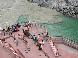 The same confluence viewed from upstream at a different time; note the swirl of sediment from the Alaknanda River