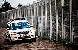 Police car at Hungary-Serbia border barrier