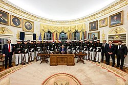 President Donald J. Trump in his capacity as commander-in-chief, welcomes the elite Marine Corps Silent Drill Platoon to the Oval Office to personally present each member with a Presidential Challenge Coin.