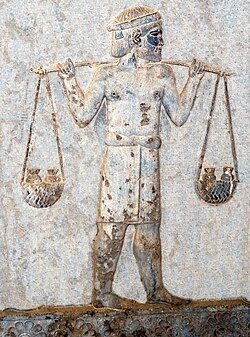 An Indian tribute-bearer at Apadana, from the Achaemenid satrapy of Hindush, carrying gold on a yoke, circa 500 BC.[90]