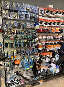 Bicycle maintenance section in a Woolworth in Frankfurt offering various parts and tools like pumps, lights, bells, handlebar grips, saddles, brakes and inner tubes