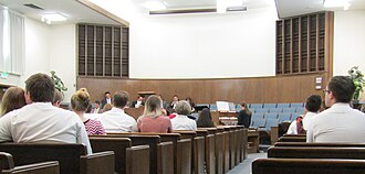 A group of people sitting in rows of seats