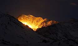 Artillery illuminating ammunition used in a shooting exercise on Simplon Pass, Switzerland. The illuminated mountain is Mount Fletschhorn, 9 km from the photographer's position.