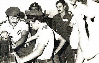 Abdullah (age 11) in uniform with soldiers