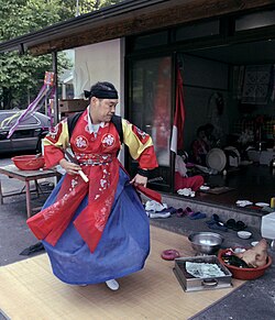 A man wearing red, blue, yellow and white clothes