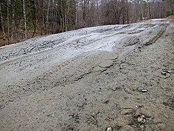 Frost heaves on a rural Vermont road during spring thaw