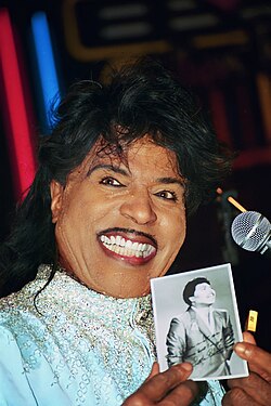 Little Richard holding a photograph of himself at a Best Buddies International event, 1998