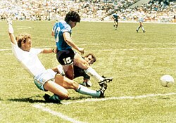 Diego Maradona shooting to score after dribbling past goalkeeper Peter Shilton.