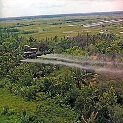 US helicopter spraying chemical defoliants in the Mekong Delta, South Vietnam, 1969