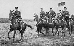 King George V reviews the 36th (Ulster) Division at Aldershot, 30 September 1915. Lord Kitchener rides in the centre of the three riders behind him, with Major General Oliver Nugent, GOC 36th Division, to Kitchener's right.