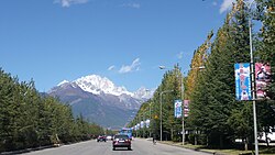 Roadway in Lijiang with the Jade Dragon Snow Mountain in the distance.