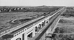 Queens Boulevard, looking east from Van Dam Street, in 1920. The newly built IRT Flushing Line is in the boulevard's median.