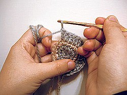 Most crochet uses one hook and works upon one stitch at a time. Crochet may be worked in circular rounds without any specialized tools, as shown here.