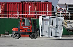 Unloading the supply ship Vestlandia operated by Royal Arctic Line at the port in Upernavik, Greenland (2007)