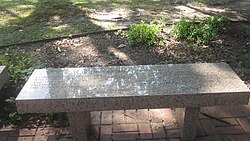 Bench at Earl Long grave inscribed, but blocked from view by the glare, with words of the C. Austin Miles hymn "In the Garden" (1912)