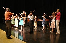 A Suzuki violin recital with students of varying ages