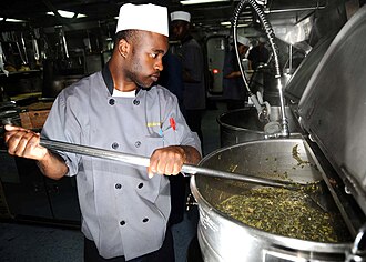 Large pot of collard greens being prepared on a US Navy ship